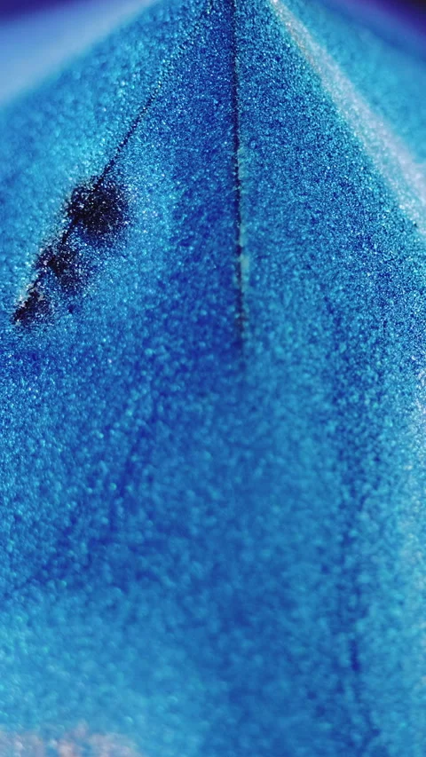 Vertical glitter pyramid paint spill blue silver Stock Footage 284686237