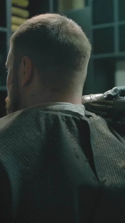 Vertical of Gloved craftsman using trimmer to align the length of the customer Stock Footage 276923243