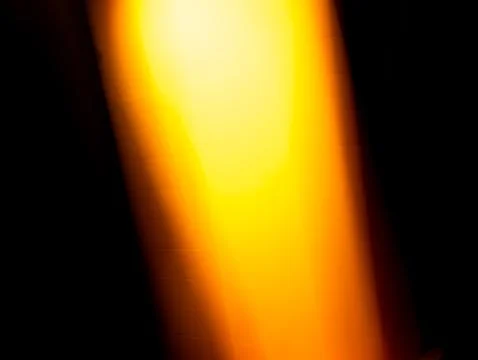 Vertical Glowing Yellow Orange Light Beam on Black Background Stock Photos