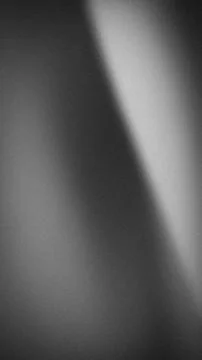 Vertical gradient black white and gray grainy blur abstract wallpaper for t.. Stock Photos