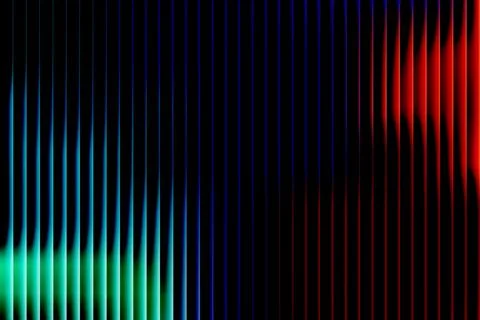 Vertical gradient lines of green blue purple and red on black background ab.. Stock Illustration