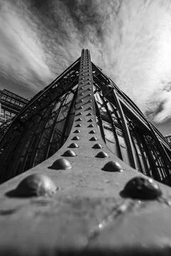 Vertical grayscale of a metallic surface of a building with a dramatic sky in th Fotos de archivo