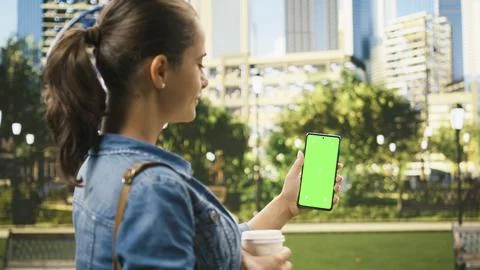 Vertical green screen chroma key on mobile phone held by woman Stock Photos