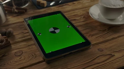 Vertical green screen digital Pad on wooden table near coffee cup on wooden Stock Footage 127798323