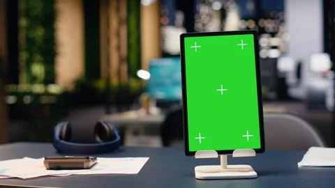 Vertical green screen in empty corporate office at night with open space Stock Photos