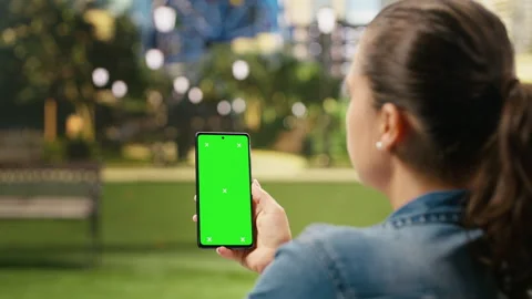 Vertical green screen isolated mockup on smartphone held by woman Stock Footage 343500946