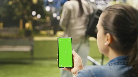 Vertical green screen isolated mockup on smartphone held by woman Foto stock