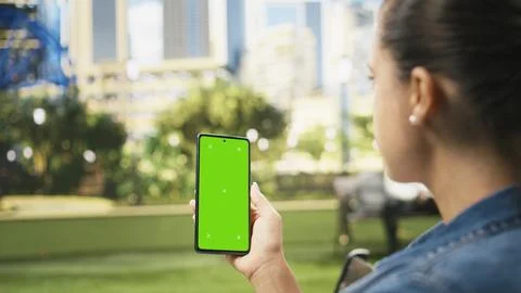 Vertical green screen isolated mockup on smartphone held by woman Stock Photos