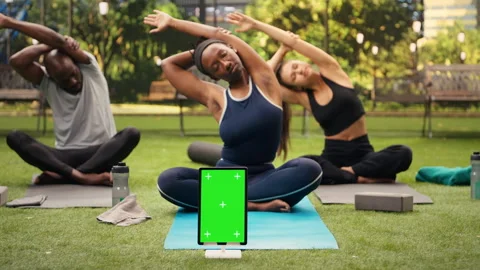 Vertical green screen mockup on tablet with editable display during yoga class Stock Footage 346025908