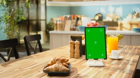 Vertical green screen on tablet in empty modern kitchen space Stock Photos