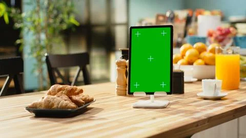 Vertical green screen on tablet in empty modern kitchen space Stock Photos
