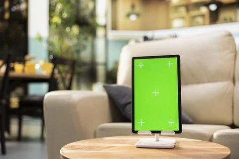 Vertical green screen on tablet in empty modern living room Stock Photos