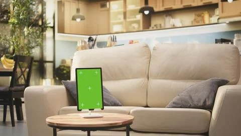 Vertical green screen on tablet in empty modern living room Stock Photos