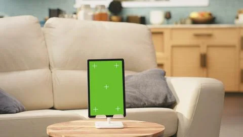 Vertical green screen on tablet in empty modern living room Stock Photos