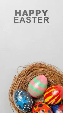 A vertical greeting card for Easter featuring hand-painted colorful eggs re.. Stock Photos