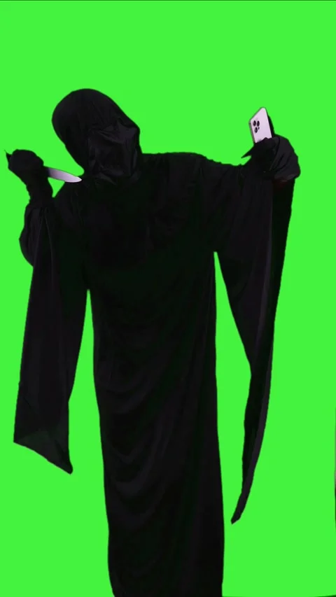 Vertical Grim reaper in Halloween costume with a knife taking a selfie with.. Stock Footage 282744366