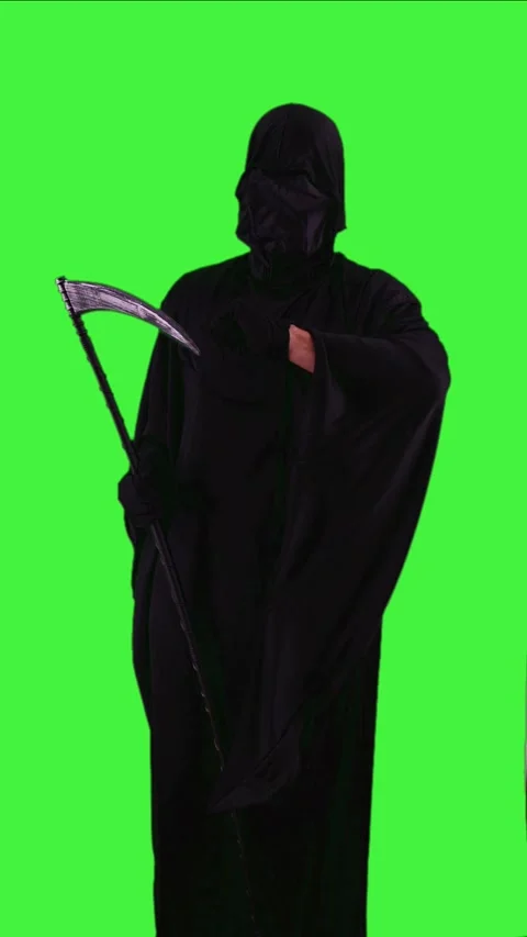 Vertical Grim reaper in Halloween costume impatiently checking the time on .. Stock Footage 282744367