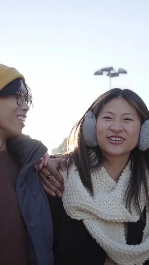 Vertical. Group of excited young friends having fun together outdoor. Diverse Stock Footage 229732428