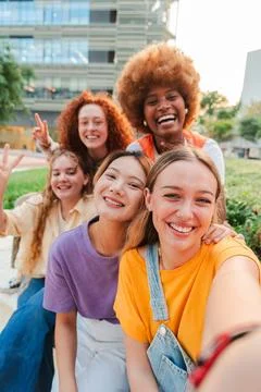 Vertical. Group of only young multiracial women taking a selfie with a Stock Photos