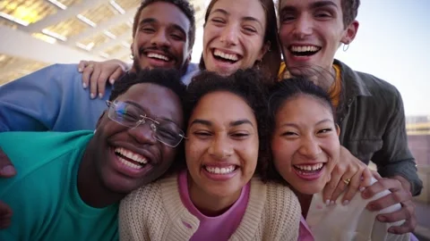 Vertical. A group of young laughing multi-ethnic people are smiling and taking Stock Footage 268293610