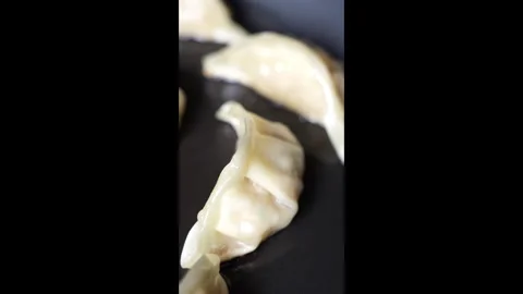 Vertical gyoza dumpling edge close-up in slow motion Stock Footage 301114505