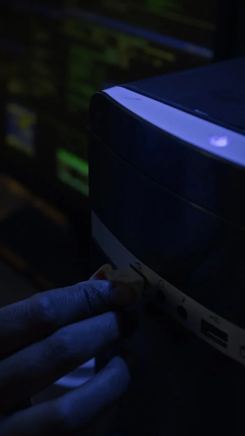 Vertical of Hackers Hand Plugging USB Cable into Computer at Night Stock Footage 328249611