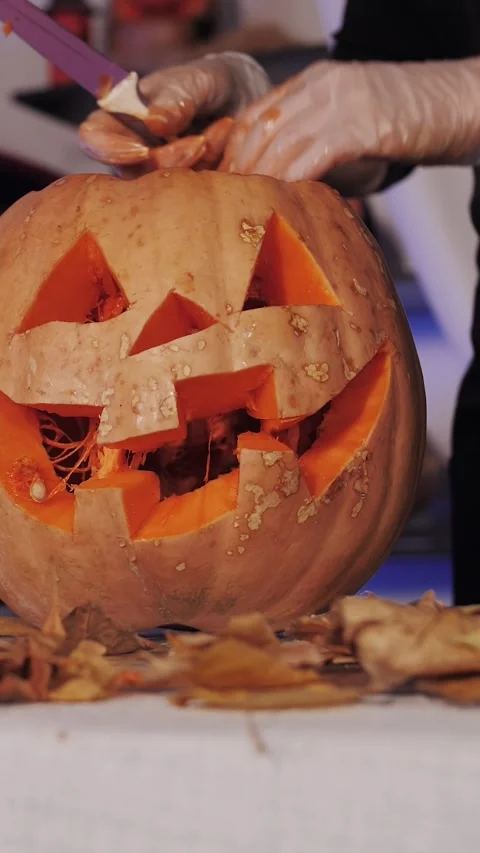 Vertical Halloween Jack-o-Lantern Close-Up: Hand Lighting a Carved Pumpkin. Stock Footage 320886483