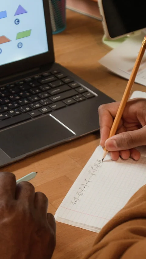 Vertical Hand of Black Boy Solving Math Equation with Tutor Stock Footage 335015961
