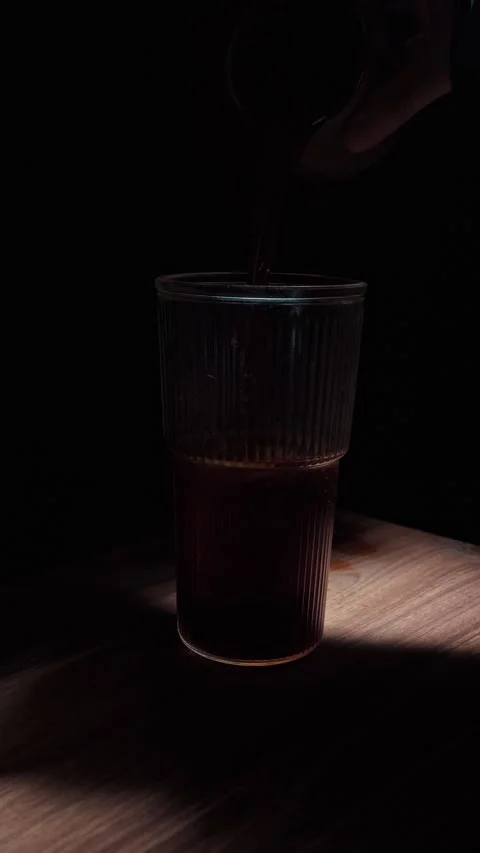 Vertical Hand Dropping Ice Pouring Espresso Dark 4K Stock Footage 325345643