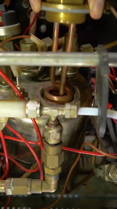 Vertical - A hand fitting a water heater element to an espresso machine boiler. Vídeos de archivo 294900293