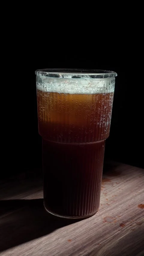 Vertical Hand Inserting Glass Straw Coffee Tonic Eco Friendly Dark 4K Stock Footage 325345185