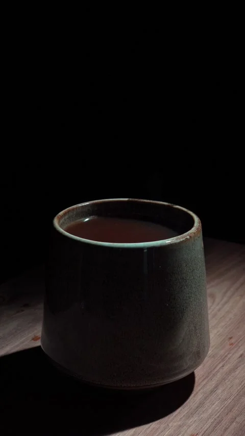 Vertical Hand Placing Coffee Cup Zoom Out Reveal Dark 4K Stock Footage 325346265