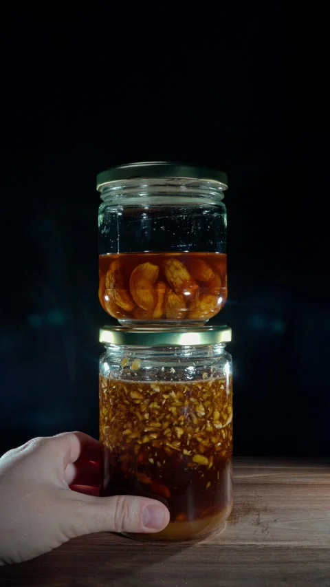 Vertical Hand Placing Stacked Fermented Honey Jars Pantry Organization Stock Footage 324922423