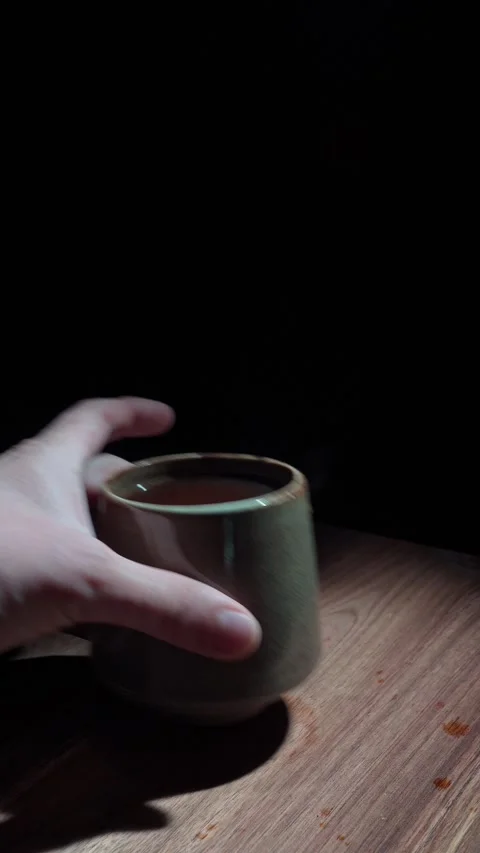Vertical Hand Removing Coffee Cup Clearing Table Dark 4K Stock Footage 325345816