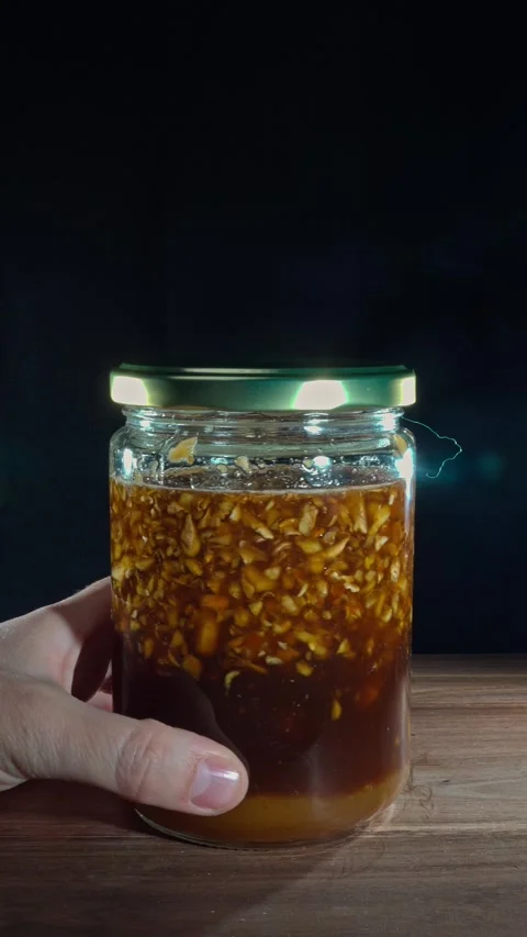 Vertical Hand Spinning Fermented Ginger Honey Jar Product Showcase Stock Footage 324921809