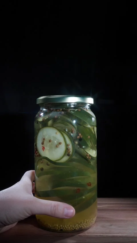 Vertical Hand Spinning Full Jar Pickled Cucumbers Preserves Display Stock Footage 324922664