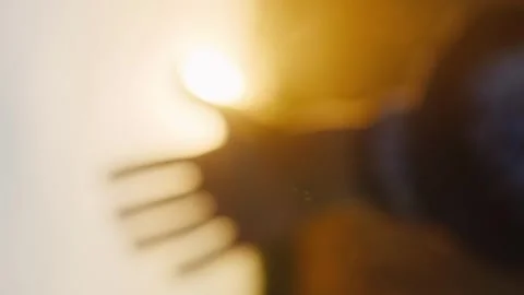 Vertical hand at sunset with the rays of the sun that slip through her fingers Stock Footage 246959172