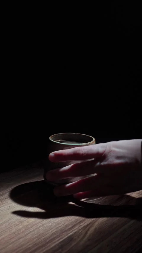 Vertical Hand Swapping Espresso Cup For Glass Transition Dark 4K Stock Footage 325345489