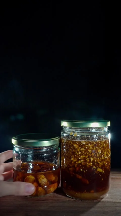 Vertical Hand Unstacking Fermented Honey Jars Placing Side By Side Stock Footage 324922468