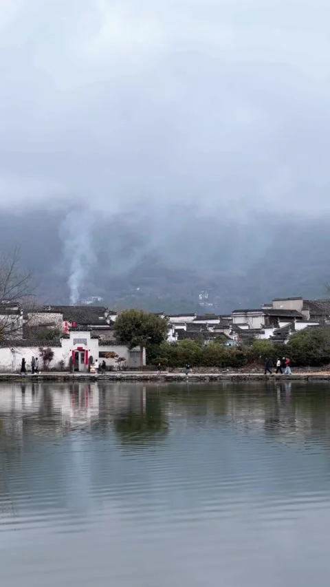 Vertical Handheld View of Ancient Village with Smoke and Mist in Hongcun Stock Footage 330146635
