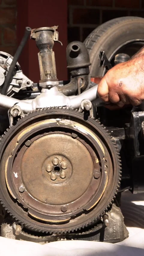 Vertical Hands and tools work together on vintage motor repair in Spain. Stock Footage 313230043
