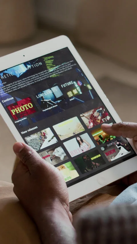 Vertical of Hands of Black Man Browsing TV Shows on Streaming App on Tablet Stock Footage 302502840