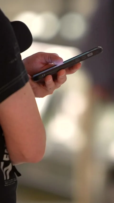 Vertical Hands holding a smartphone inside the terminal at modern airport. Stock Footage 292910621