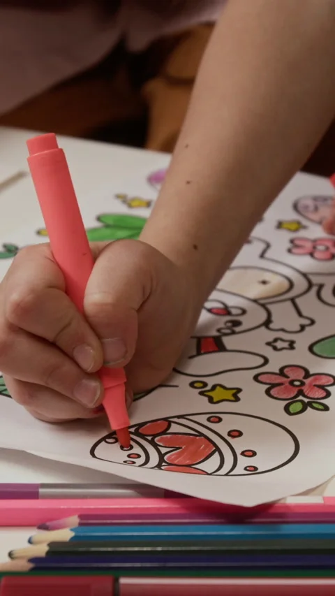 Vertical of Hands of Kid Coloring Easter Egg Drawing Stock Footage 327888838