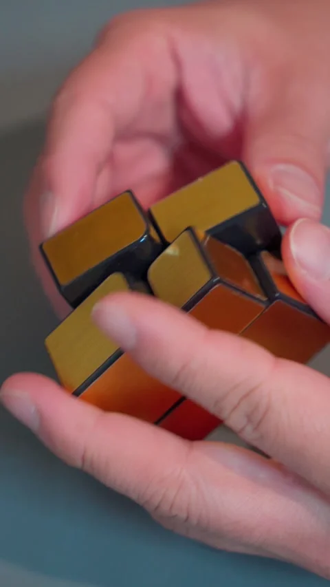 Vertical Hands Solving Golden Mirror Cube Puzzle 9x16 Stock-Footage 340179158