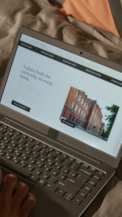 Vertical of Hands of Student Browsing University Website on Laptop Computer Stock Footage 338095912