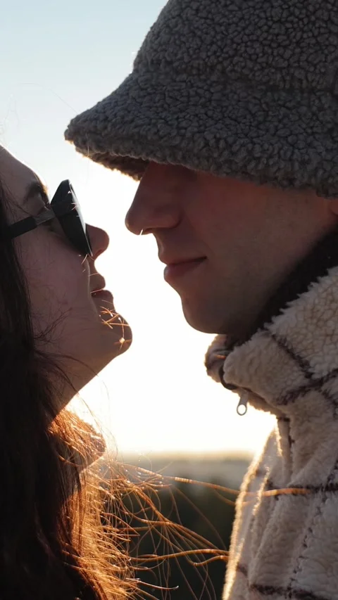 Vertical. Happy young couple looking at each other silhouette in winter at Video stock 328534116