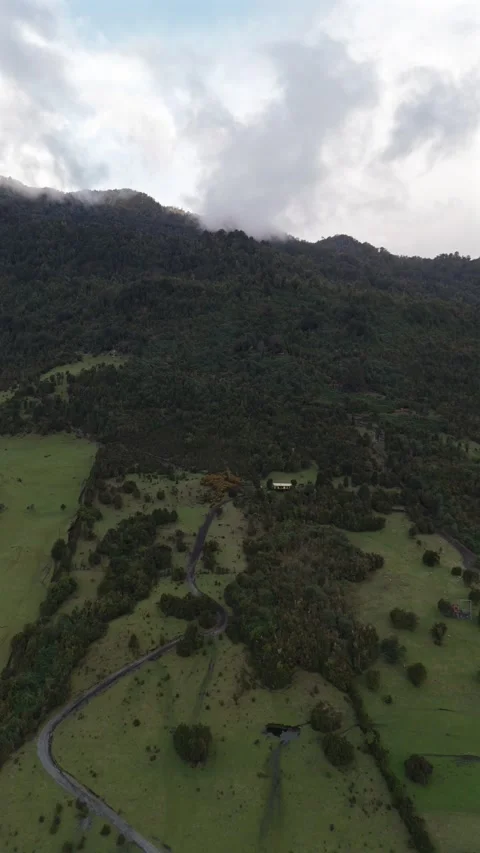 Vertical High Aerial Over Mountain Slope with Remote House Among Trees Vidéo 326078602