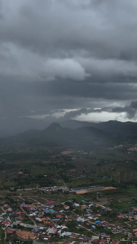 Vertical high aerial view Heavy monsoon rain sweeps over green mountain valley Stock Footage 314931467