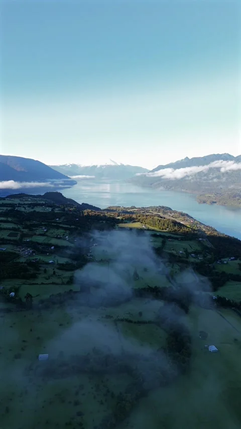 Vertical High Altitude Aerial Pull Away Above Clouds Over Cochamó Valley Stock-Footage 329067407